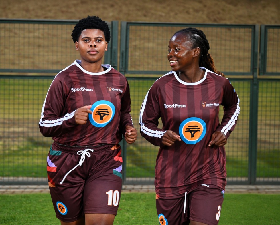 Two walter sisulu soccer player dressed in their women's soccer team kit. 